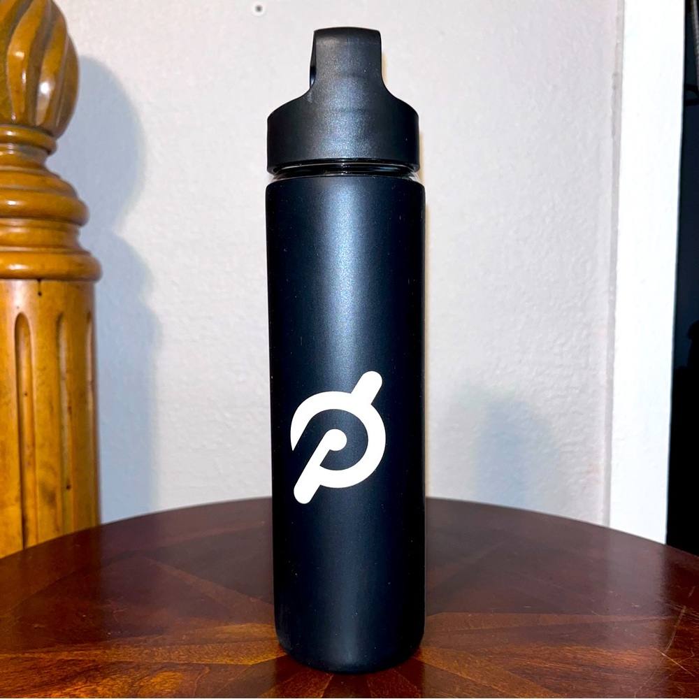Peloton Glass water bottle with black silicone cover. 16 oz.